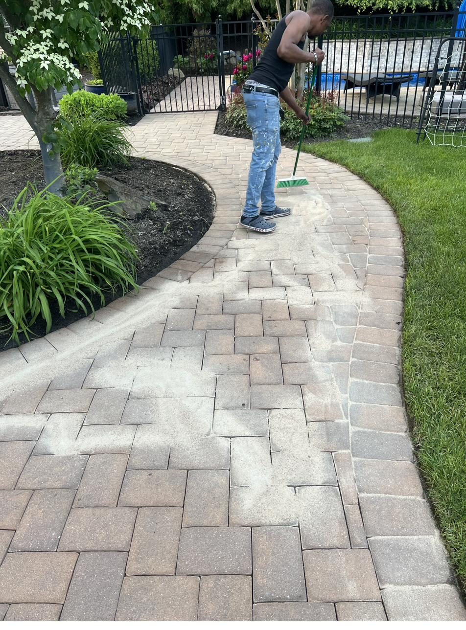 Skyview crew member installing a paver walkway